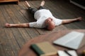 Man meditating on a wooden floor and lying in Shavasana pose after practice Royalty Free Stock Photo