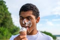 Man with melted ice cream on his face outdoors in summer Royalty Free Stock Photo