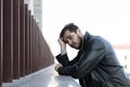 a man with a mental illness who is depressed holds his head and looks away prostration