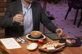 Man with menu in a restaurant taking order at table Royalty Free Stock Photo