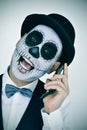 Man with mexican calaveras makeup, on the phone Royalty Free Stock Photo