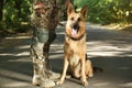 Man in military uniform with German shepherd dog, closeup view Royalty Free Stock Photo
