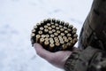 a man in military uniform holds a machine gun belt with used machine gun casings Royalty Free Stock Photo