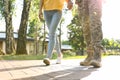 Man in military uniform walking with his girlfriend at park, closeup