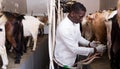 Man milking goats on farm