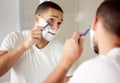 Man, mirror and shaving beard in bathroom for hygiene or grooming with self care, wellbeing and reflection. Home Royalty Free Stock Photo