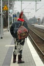 Punk mit spiked colorful hair waits for the train