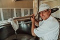 Man mixing milk in the stainless tank during the fermentation process at the cheese manufacturing