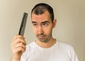 Man model black hair young closeup hair loss hold hair brush