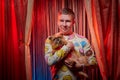 Man model with a small dog on the theater stage. Photo shoot in the circus style