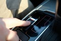 A man in a modern car. Hand presses the auto parking button Royalty Free Stock Photo