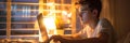 Man at modern desk with laptop, cityscape reflection, and plant, immersed in focused work