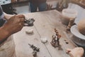 Man molding clay to make ceramics with his hands, Artisan working in his workshop, Selective Focus