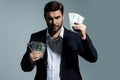 Man with money cash. Dollar banknotes. Portrait of man holding bunch of money banknotes. Dollar bills, credit, online