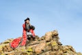 Man in Mongolian costume on rock Royalty Free Stock Photo