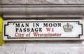 Man in moon passage street sign, London