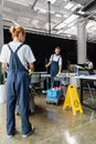 man with mop and cart with