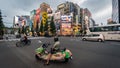 Man on a motorbike with manga figures at Akihabara Crosswalk Junction in the evening with colorful lights, Tokyo, Japan