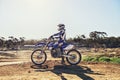 Man, motorbike and outdoor on trail for extreme sport in profile on dirt, path or countryside in summer. Person Royalty Free Stock Photo