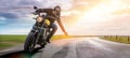 Man on a motorbike on the road riding. having fun driving the empty road on a motorcycle tour journey. Royalty Free Stock Photo