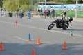 A man motorcycle maneuvers obstacles road