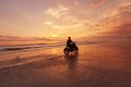 Man And Motorcycle On Ocean Beach At Beautiful Tropical Sunset. Biker Silhouette On Motorbike.