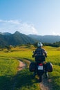 Man motorcyclist ride touring motorcycle. Alpine mountains on background. Biker lifestyle, world traveler. Summer sunny sunset day