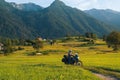 Man motorcyclist ride touring motorcycle. Alpine mountains on background. Biker lifestyle, world traveler. Summer sunny sunset day