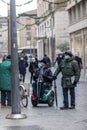 Man with motorized wheelchair and friends talking in the city center Royalty Free Stock Photo