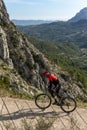 Man with mountain bike on a concrete country road. Royalty Free Stock Photo