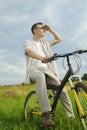 A man on a mountain bike. A fashionable guy came to nature in the field