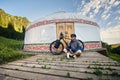 Man with mountain bike near yurt house in the mountain