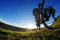 Man on mountain bike rides on the trail on a beautiful sunrise. Bicycle wheel closeup. Royalty Free Stock Photo