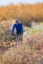 Man mountain biking in autumn