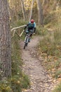 Man mountain biking in forest.