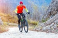 Man mountain biking uphill ride on concrete road Royalty Free Stock Photo