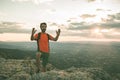 Man on the mountain pointing towards the sky. Guy practicing trekking