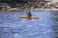 04.2019.Czech.A man on a mountain river is engaged in rafting. A girl is kayaking down a mountain river.girl in a kayak, side view Royalty Free Stock Photo