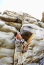 Man, mountain and rock climbing or chalk for grip as outdoor performance, adventure or gear. Male person, hanging and