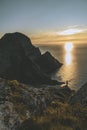 Man mountaineer standing on rock of peak mountain at sunset. Ryten Mountain, Norway