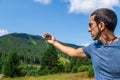A man in the mountains holds a compass in her hands. Selective focus. Royalty Free Stock Photo