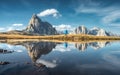 Man and mountains reflected in lake at sunset in autumn Royalty Free Stock Photo