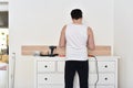 Man mounting shelves on the wall. All necessary tools are placed on the chest of drawers Royalty Free Stock Photo