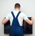 Man mounting TV. Royalty Free Stock Photo