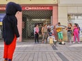 Man in mouse costume stops to listen to some street musician in Wiesbaden, Germany