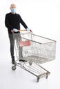 Man with mouth protection and hand gloves pushing a shopping cart, isolated on white background