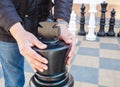 Man moving giant chess piece king outdoor Royalty Free Stock Photo