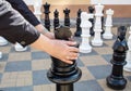 Man moving giant chess piece king outdoor Royalty Free Stock Photo