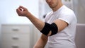Man moving hand in elbow padded orthosis, recovery after sport trauma healthcare