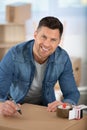 man moving in new apartmentsitting surrounded with cardboard boxes Royalty Free Stock Photo